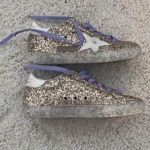 Golden Goose Super-Star distressed
Gilttered Leather Sneakers $250